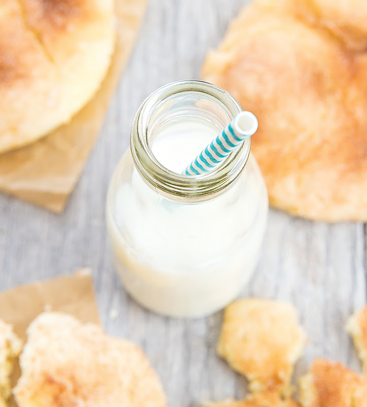 overhead photo of a small jug of milk with a straw