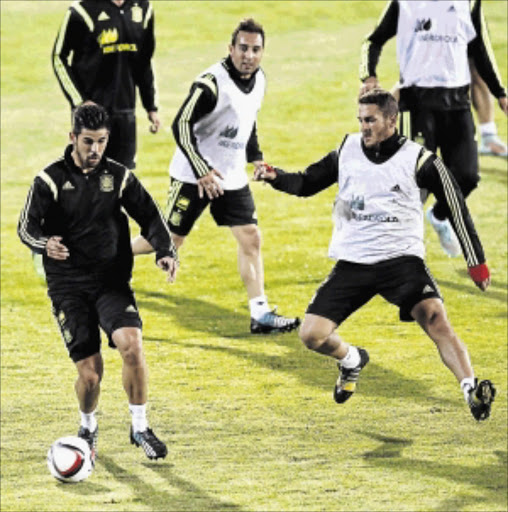 DEPLETED: Spain's striker Manuel Agudo Duran, left, battles for the ball with midfielder Koke Resurreccion in a training session at FNB Stadium in Las Rozas, near Madrid. PHOTO: Alberto Martin/EPA