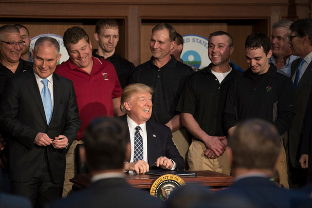 Scott Pruitt, left, administrator of the Environmental Protection Agency, with President Trump and a group of coal miners in March as the president signed an executive order that rolled back many climate-change policies. Photo: Stephen Crowley / The New York Times