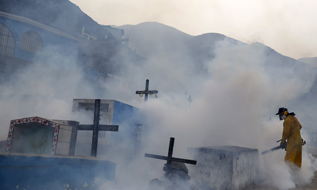 A health worker fumigates a cemetery in Carabayllo on the outskirts of Lima, Peru, to stem the spread of the mosquito-borne Zika virus. Photo: Reuters