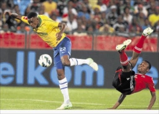 BEATEN: Siyabonga Sangweni of Orlando Pirates is left kicking the air as Mamelodi Sundowns' Jabulani Shongwe pips him to the ball during their league match at Loftus Stadium last night. PHOTO: ANTONIO MUCHAVE