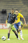 MY BALL: Platinum Stars' Tshepo Gumede, left, runs away with  the ball  from Mamelodi Sundowns'  Eleazer Rodgers during their clash at the weekend.
       Photo: Gallo Images