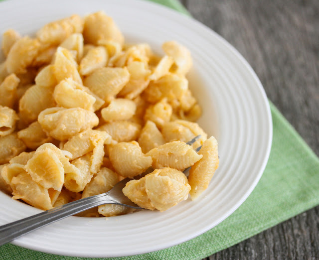 photo of a bowl of macaroni and cheese with a fork