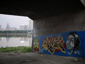 graffiti with images of a tiger and a woman under a bridge in Changsha
