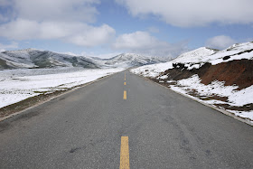 road scene with snow covered mountains in Qinghai, China