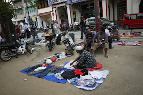 man selling clothes at an outdoor market in George Town, Penang, Malaysia