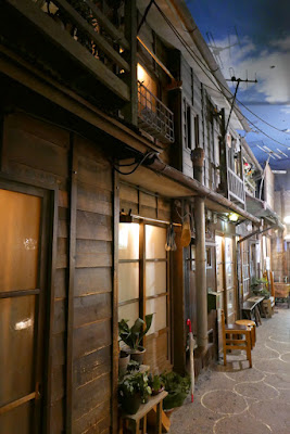 Inside the Shin-Yokohama Raumen Museum, featuring a streetscape like it's 1958 there are even sound effects on loundspeakers of monks chanting, or a cat meowing, or movies or radio music from the era, as you walk down the fake alleys of a neighborhood of homes and bars