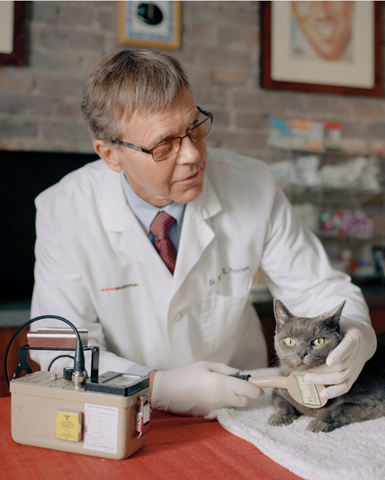 Dr. Mark Peterson with a patient at his Manhattan clinic. Dr. Peterson treats thyroid hot spots in cats by injecting them with radiation. He keeps them as comfortable as possible during their stay at the “Hypurrcat Spa”. Photo: Mark Peckmezian / The New York Times