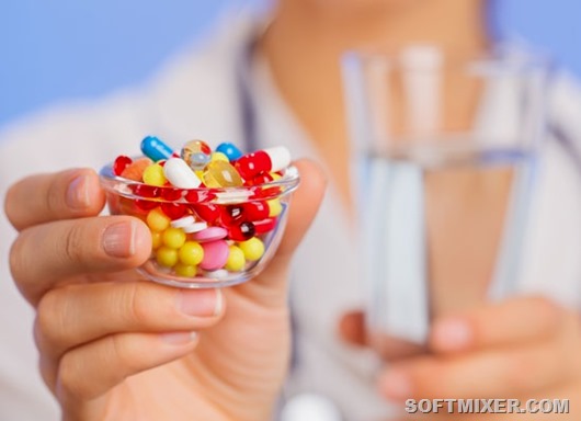 Pills, tablets and drugs heap in doctor hand, closeup view 