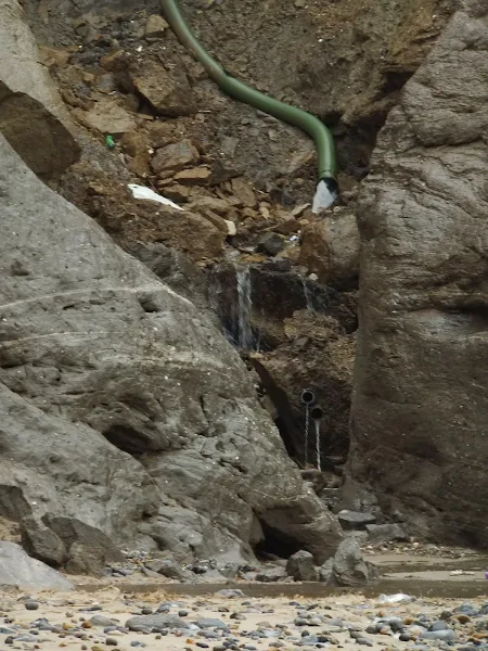 Water pouring down cliffs at Beeston