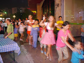 adults and children in a conga line