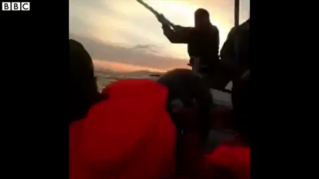 Turkish coast guards using sticks against a boat full of migrants as they sail to Greece in the Aegean Sea. A woman is heard screaming as the migrant boat is hit by two men with sticks. Photo: BBC News