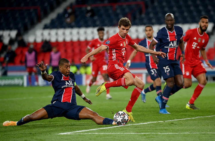 Thomas Mueller of FC Bayern Munich is challenged by Presnel Kimpembe of Paris Saint-Germain during the UEFA Champions League quarter-final, second leg match at Parc des Princes on April 13, 2021