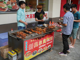 chicken cooking at a New Orleans Roast Chicken food stall