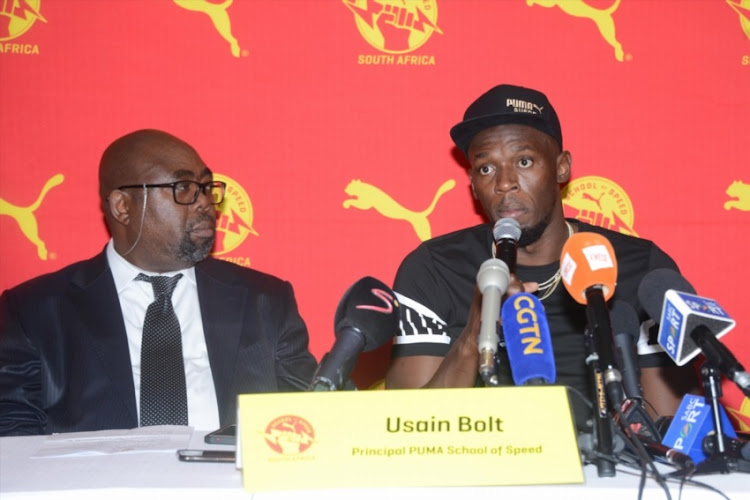 Minister of Sport and Recreation, Thulas Nxesi and Retired Jamaican athletic superstar Usain Bolt during the PUMA School of Speed competition at Ruimsig Stadium on January 29, 2018 in Johannesburg.