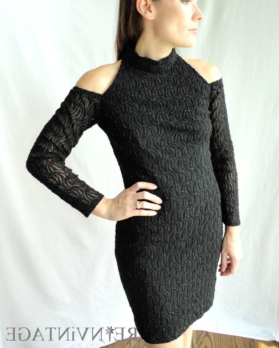 High neck and retro cut out shoulders with long sleeves.