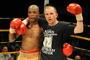 Thomas Makwana (white trunks) celebrates his victory during the Junior Lightweight Bout held at Emperors Palace in Kempton Park, Johannesburg, South Africa. 