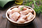 A bowl of fresh chicken pieces.