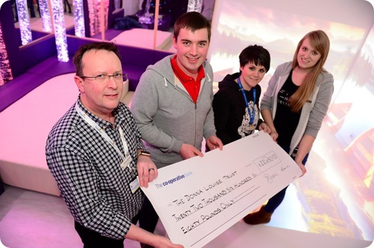 Pictured left to right: Mike McDonald - Chief Executive at DLH, Graham Witter, Nikki Wrench - Challenge Events Manager, and Nikki Culverwell - Play Specialist

Cheque presentation to the Donna Louise Hospice of £22680 from Weston Christmas lights

It has always been my pleasure to organise the 'Weston Christmas Light Display' for a children's hospice which has done so much for my family. My late sister, Jessica had a truly amazing fascination for colour; light; and sound which was my inspiration in 2013 to organise a local community Winter Wonderland!

I started decorating the house with animated characters; filling the garden with inflatables and making our family home like a mini 'North-Pole'! It enabled me to bring our community together whilst creating a local family tradition which many families and young children can enjoy. 
But at the heart of this event was a 'thank-you', for all the respite care, family support and home activities the care team provided my Sister. After losing my close sibling in December 2015 having raised £17,000, it felt I should continue my event in her memory. With new lighting ideas, a festive 'Mr Whippy' van and the opportunity for a 'Sleigh Selfie with Santa', the 2016 display delivered an astounding success, raising £22,680.00.
I have so much satisfaction that my time, commitment and dedication is helping improve the lives of children, young people and their families across our community. To know my event has thrilled festive visitors, but most importantly improved services the hospice can offer, gives me satisfaction to continue my fundraising.
As an ambassador for the hospice I am hoping to draw up exiting plans for the 2017 display...and hope to fascinate visitors with a festive magical experience that cannot be missed! Let's hope Santa can continue wrapping our presents, so he can make a trip back with the reindeers this year! - Graham
