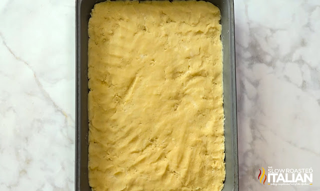 dough pressed into baking pan