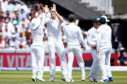 Morne Morkel celebrates with teammates after taking the wicket of England's Gary Ballance.