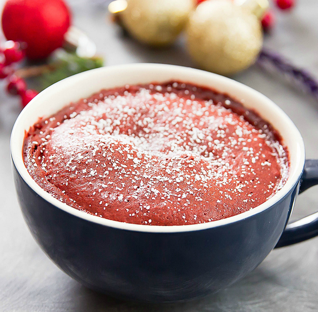 photo of a Red Velvet Lava Mug Cake dusted with powdered sugar