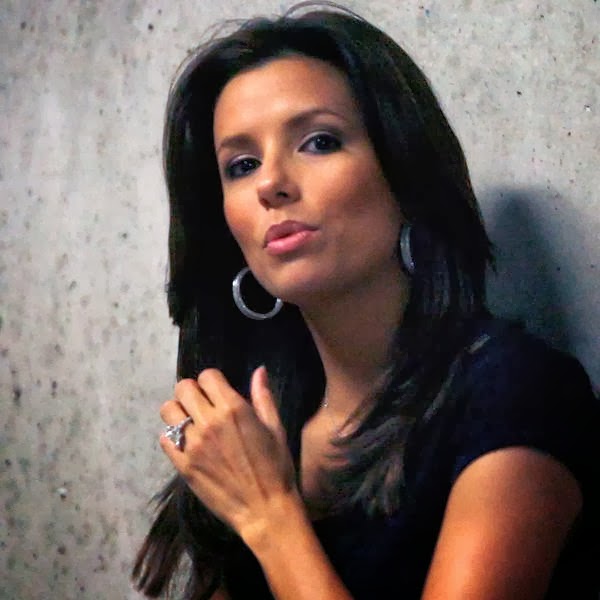 Actress Eva Longoria waits in a stadium hallway as the San Antonio Spurs play the Utah Jazz during Game 3 of their NBA Western Conference Final playoff basketball series in Salt Lake City, Utah.