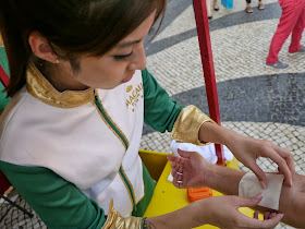 young woman putting a temporary tattoo on my arm