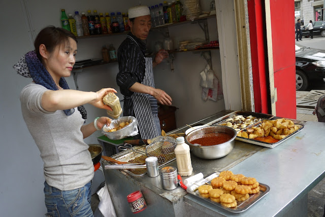 man and woman selling potatoes and other foods in Lanzhou, China