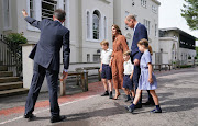 The Cambridges are shown to the front door of Lambrook School by the head, Jonathan Perry.