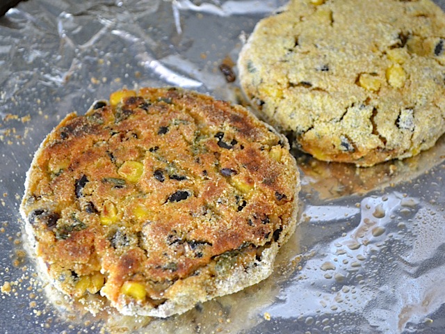 baked burgers on baking sheet lined with tin foil 