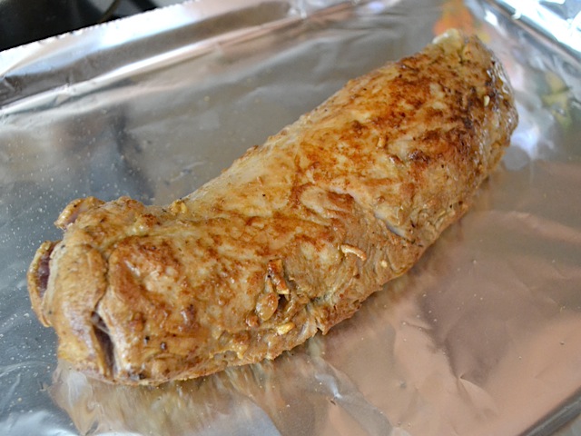 browned tenderloin placed on baking sheet lined with tin foil to roast in oven