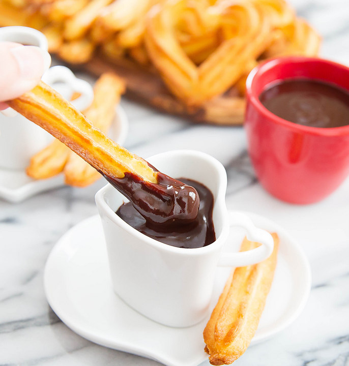 close-up photo of a chocolate dipped baked churro