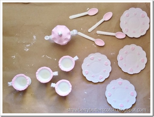 Adding pink paint to bring out the details in the cute dishes and cups.  There are little hearts and flowers!