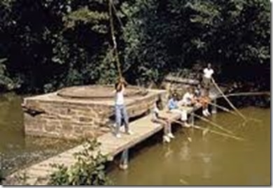 Afro_american_kids_fishing_from_wooden_bridge