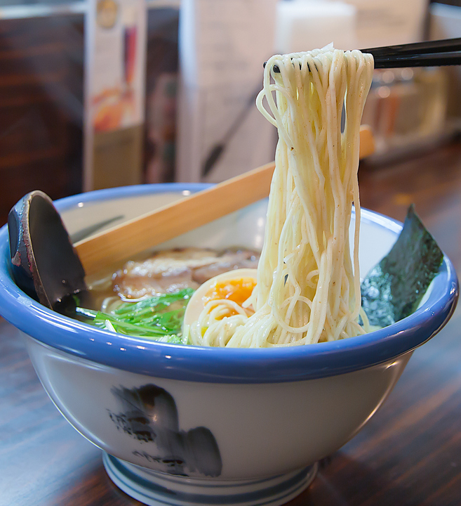 photo of chopsticks with ramen