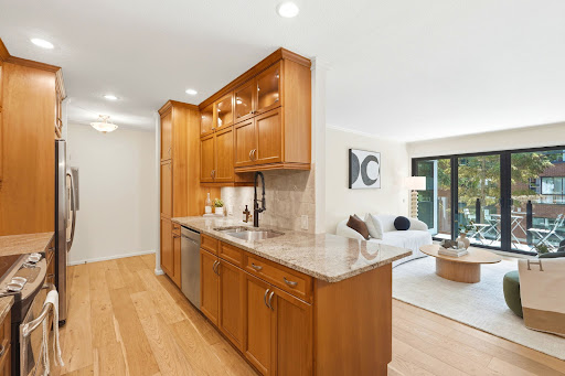 Modern kitchen with wooden cabinets and granite countertop in this luxury apartment / penthouse for sale in Kirkland ($945,950)