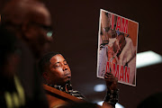 A person holds a placard with a picture of Tyre Nichols during a news conference held by the family members of Nichols, the Black man who was beaten by Memphis police officers during a traffic stop and died three days later, at Mason Temple: Church of God in Christ World Headquarters, in Memphis, Tennessee, US, January 31, 2023. 