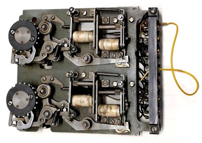 A counter unit from an IBM accounting machine. The two wheels held two digits. The electromagnets (white) engaged and disengaged the clutch so the wheel would advance the desired number of positions.