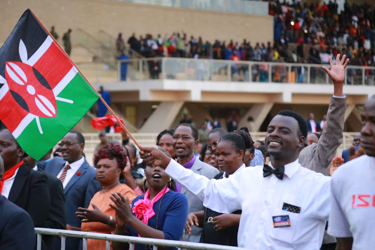 A man waving the Kenyan flag during the first day of the Benny Hinn- mega crusade at Nyayo Stadium in Nairobi on February 24, 2024.