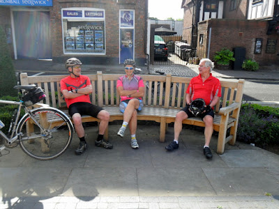 3 sitting on curved bench