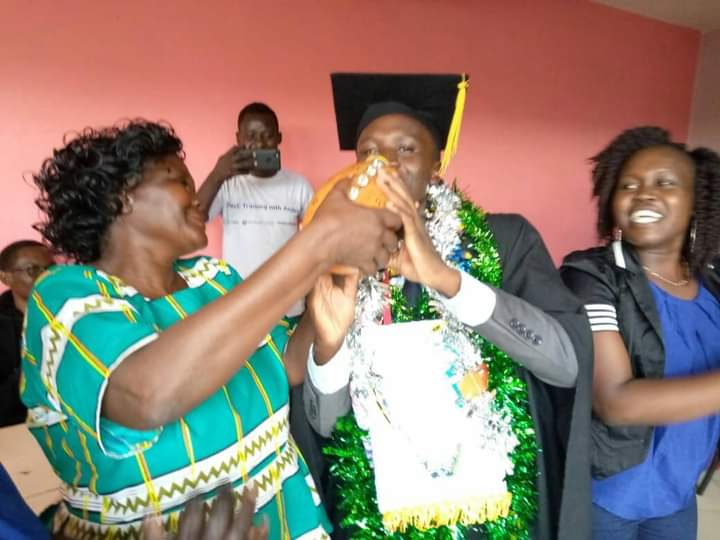 Boaz Komen drinks mursik fermented milk from a calabash served by his mother Linah Chesire during graduation last year