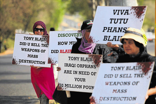 Protesters outside the Discovery Invest Leadership Summit in Sandton, where former British prime minister Tony Blair was one of the keynote speakers yesterday Picture: ALON SKUY