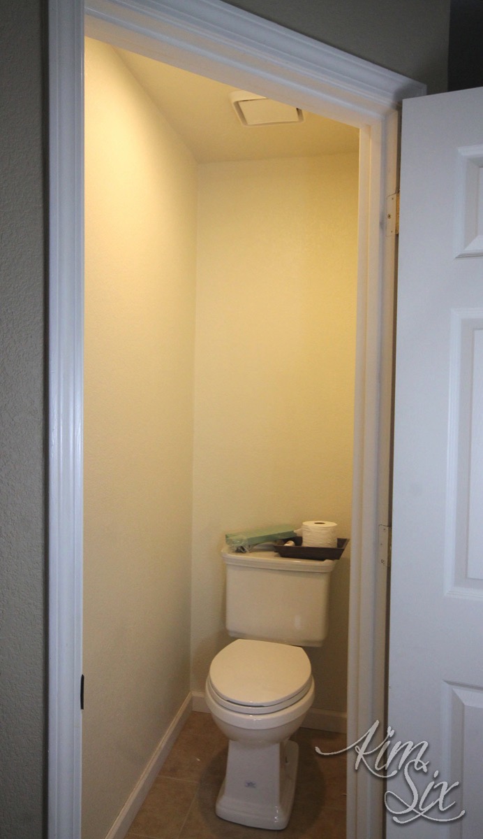 Water closet with angled entry door