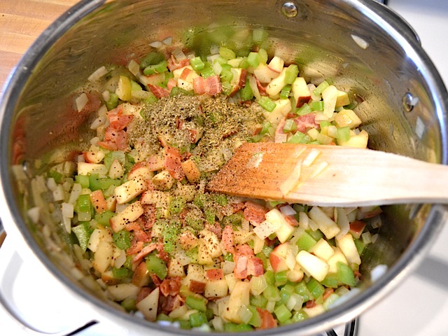 seasoning added to pot of veggies and bacon 