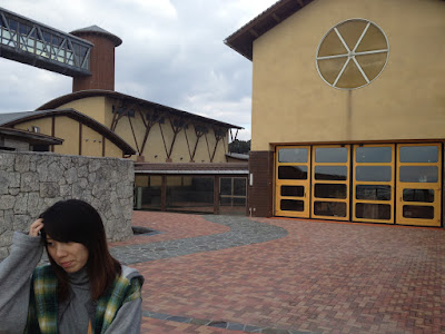 Katie on a brick patio near a building