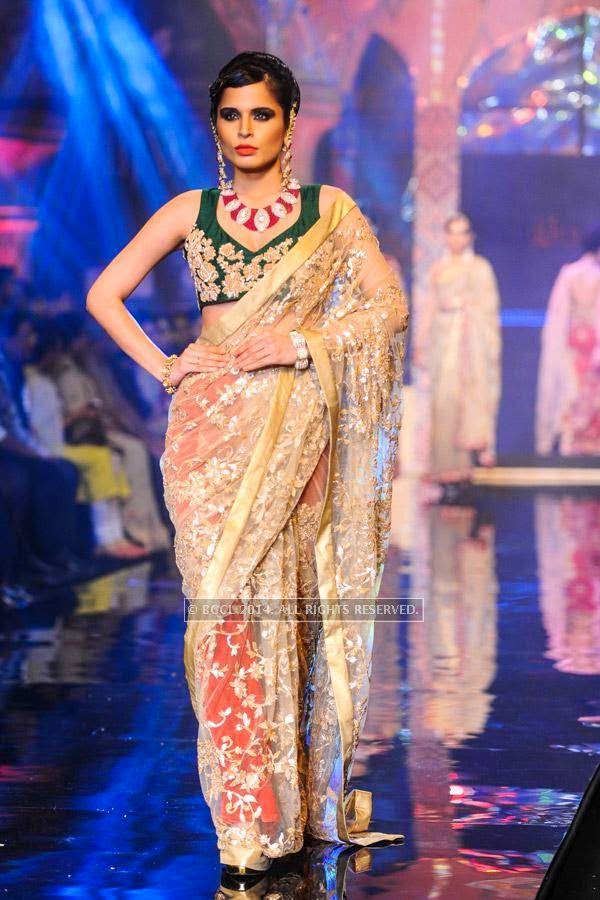 A model walks the ramp for Bridhichand Ghanshyamdas Jewellers on Day 3 of India International Jewellery Week (IIJW), 2014, held at Grand Hyatt, in Mumbai.