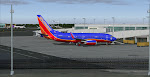 At the gate in Providence as a Delta MD-88 lands runway 23 in the background