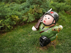 small sculpture of a marching soldier outside the Parkview Green in Beijing