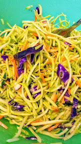 Tossing the dressing and broccoli slaw, which is a mix of broccoli, cabbage, carrots that are shredded for Ramen Noodle Broccoli Slaw